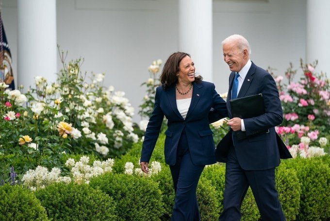 Kamala Harris and Joe Biden walk together, displaying unity and support for her presidential bid.